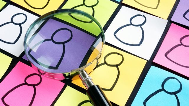 magnifying-glass-looking-at-different-person-profiles